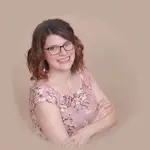 Kristy Goodwin, smiling in a floral dress, local Navigator Network leader