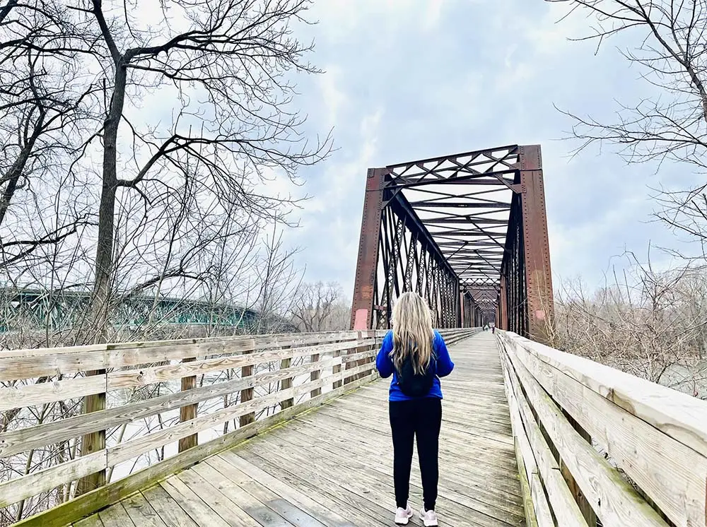 Faith-based marketing consultant walking across bridge symbolizing purpose-driven business journey